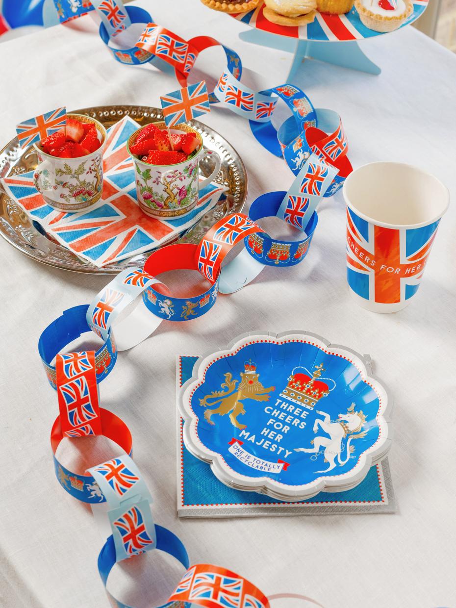 A Jubilee celebration with napkins, plates, cups and paper chains with plenty of tea and cake.